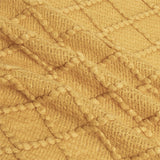 Up close image showing the colour, pattern, and texture details of the yellow throw blanket.