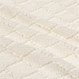 Up close image showing the colour, pattern, and texture details of the cream throw blanket.