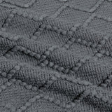 Up close image showing the colour, pattern, and texture details of the dark grey throw blanket.