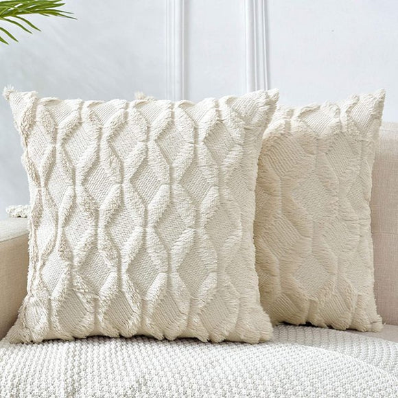 Cream pillows with rows of diamonds. Outlining each diamond is a soft, raised material.